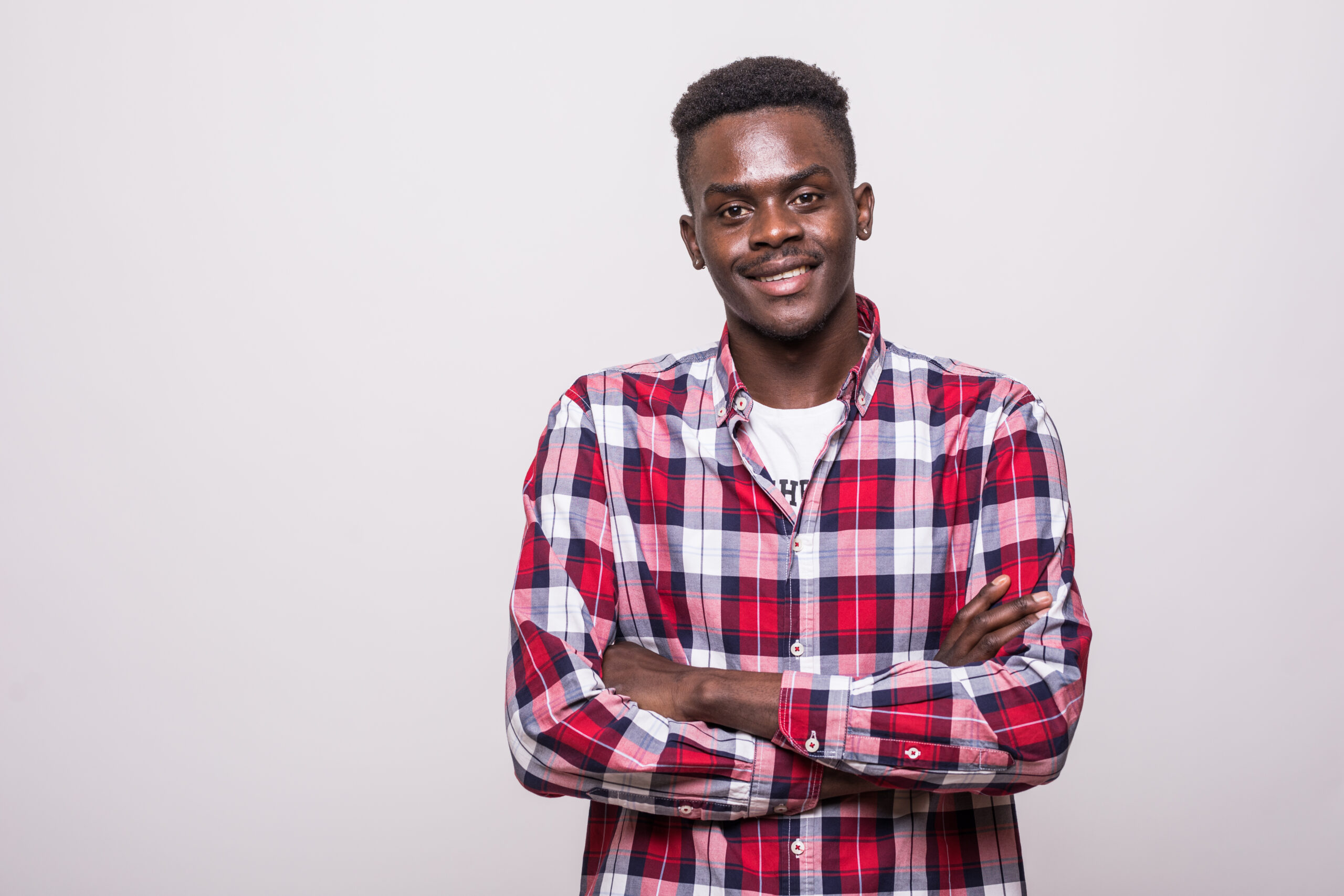 young afro american man with arms crossed isolated on white background